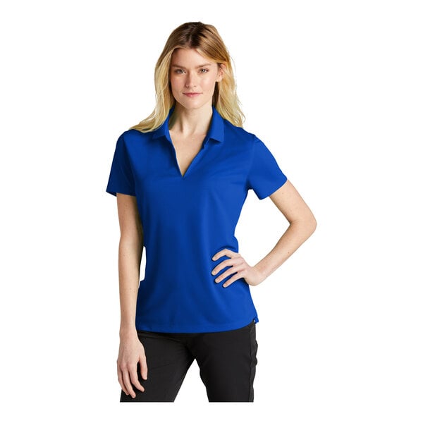 A woman wearing a blue Nike polo shirt with black trim.