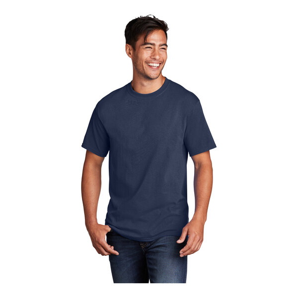 A man smiling and wearing a Port & Company navy blue short sleeve t-shirt.