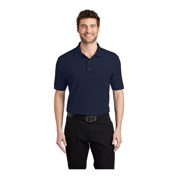 A man wearing a navy Port Authority® polo shirt.