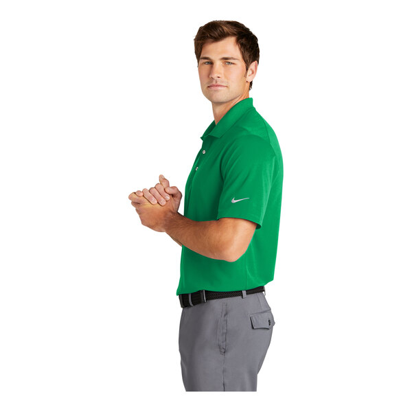 A man wearing a green and white Nike Dri-Fit polo shirt.