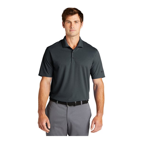 A man wearing a dark gray Nike polo shirt.