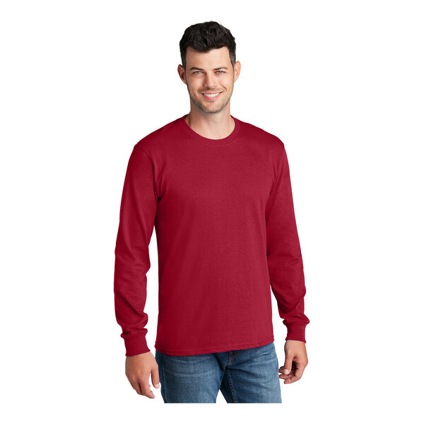 A man wearing a red Port & Company long sleeve t-shirt.