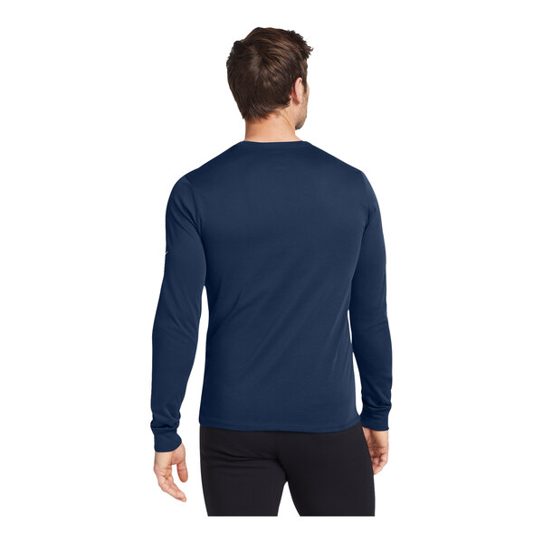 A man wearing a college navy Nike Dri-FIT long sleeve shirt.