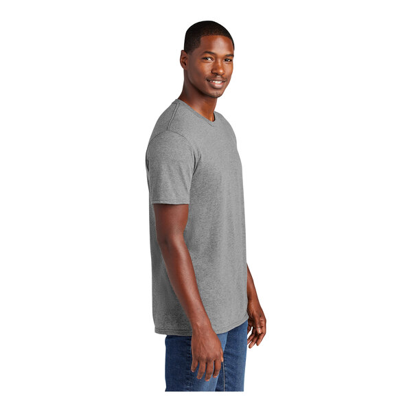 A man wearing a District grey short sleeve t-shirt.