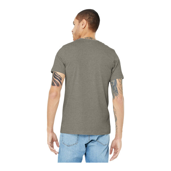 A man wearing a Bella + Canvas heather stone t-shirt.