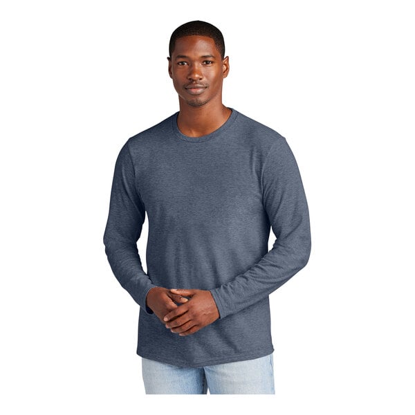 A man wearing a heathered navy District long sleeve t-shirt.