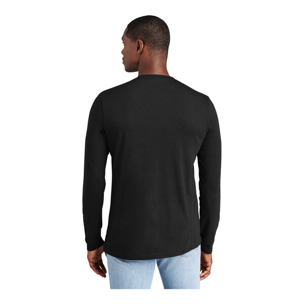 A man wearing a black District long sleeve T-shirt.