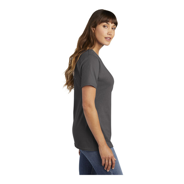 A woman wearing a Port & Company charcoal grey short sleeve t-shirt.