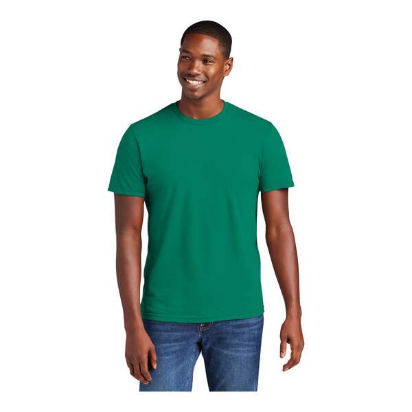 A man wearing a District Unisex Jewel Green short sleeve t-shirt.