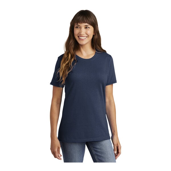 A woman wearing a navy Port & Company t-shirt.