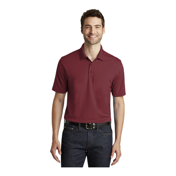 A man wearing a burgundy Port Authority Dry Zone polo shirt.