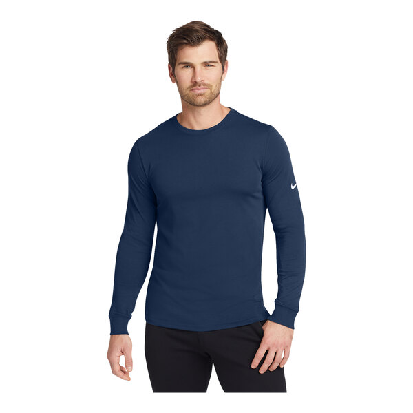 A man wearing a Nike College Navy long sleeve t-shirt.