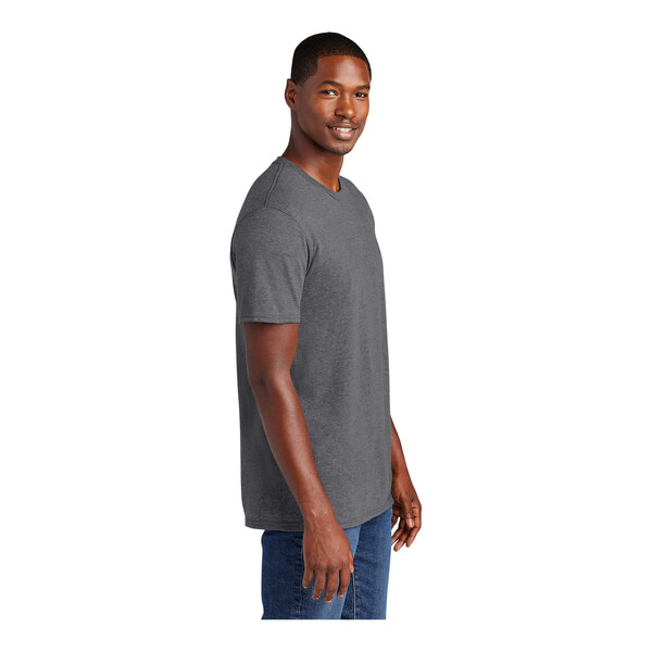 A man wearing a District Heathered Charcoal T-shirt smiling.