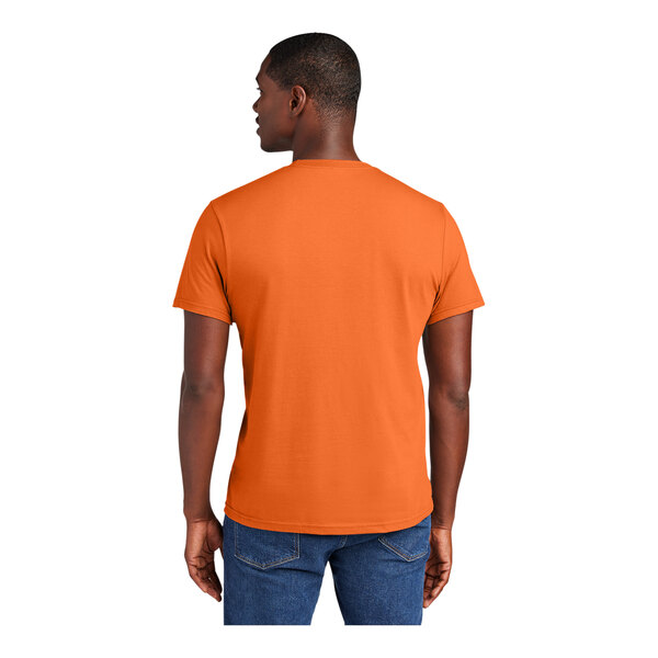 A man wearing an orange District t-shirt.