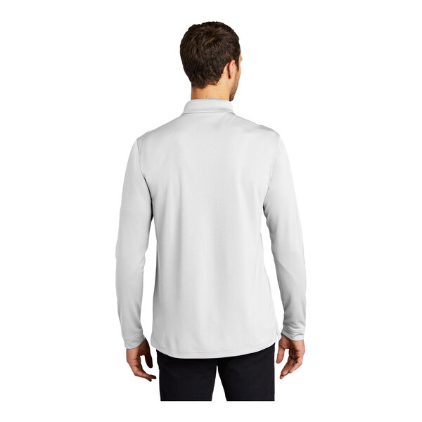 A man wearing a white Port Authority long sleeve polo shirt.