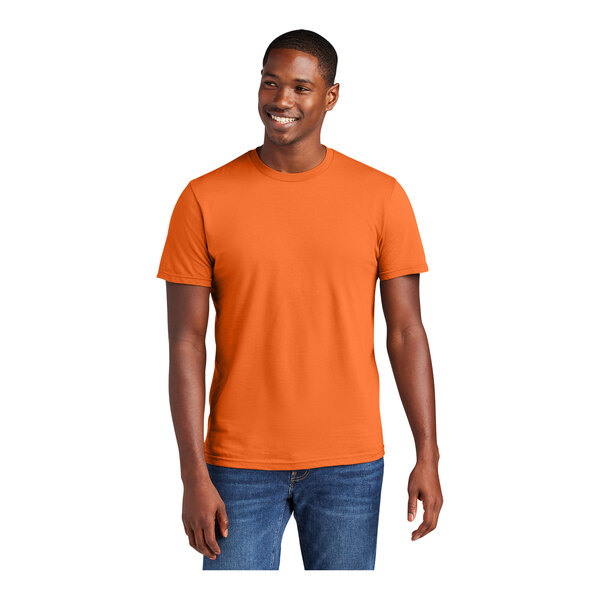 A man wearing an orange District T-shirt smiling.