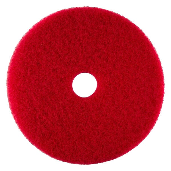 A red circular Scrubble by ACS buffing pad with a hole in the middle.