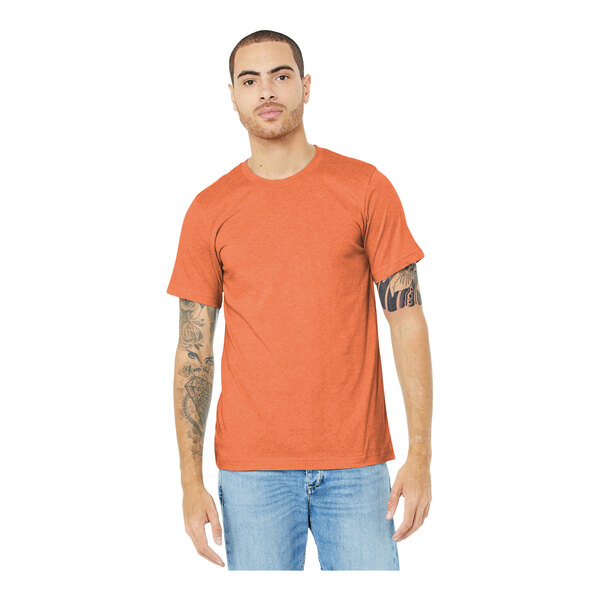 A man wearing a Bella + Canvas heather orange t-shirt.
