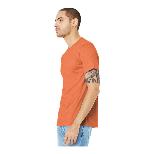A man wearing a Bella + Canvas heather orange t-shirt.