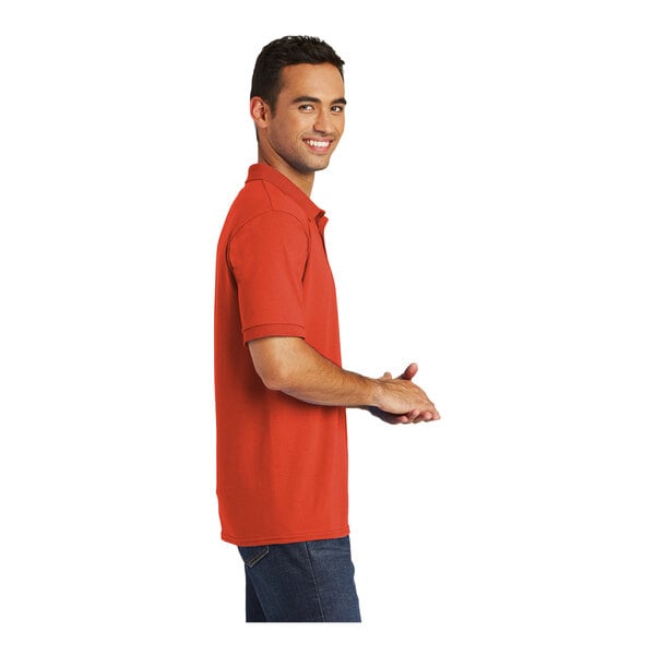 A man wearing an orange Port & Company polo shirt.