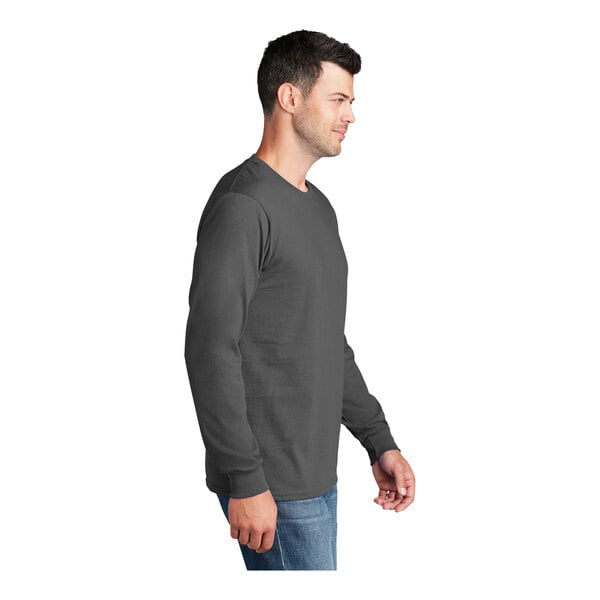 A man wearing a Port & Company long sleeved t-shirt.