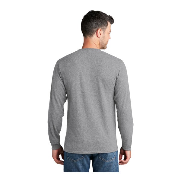 A man wearing a Port & Company athletic heather long sleeve shirt.