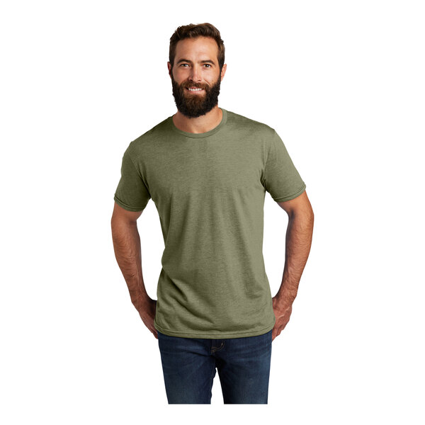 A man with a beard wearing an olive green AllMade short sleeve t-shirt.