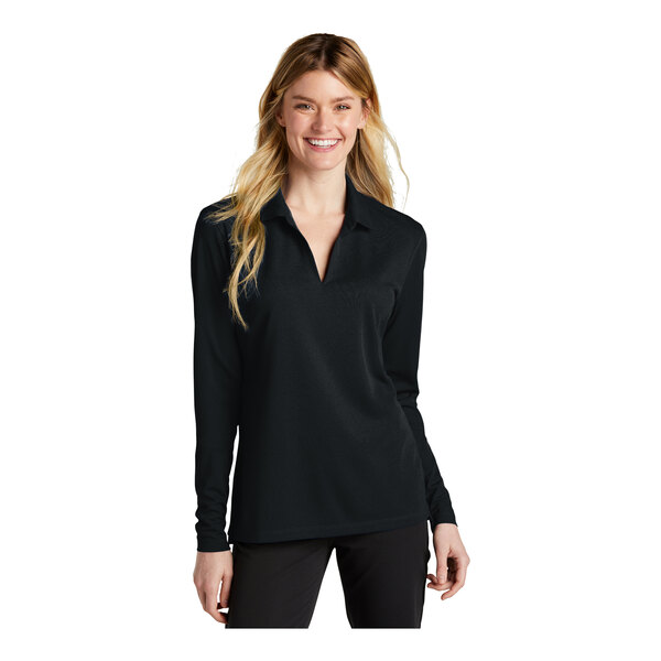 A woman wearing a black Nike long sleeve polo shirt.