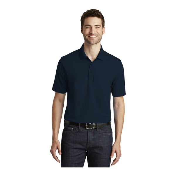 A man wearing a navy Port Authority Dry Zone polo shirt.