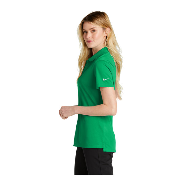 A woman wearing a green Nike polo shirt.