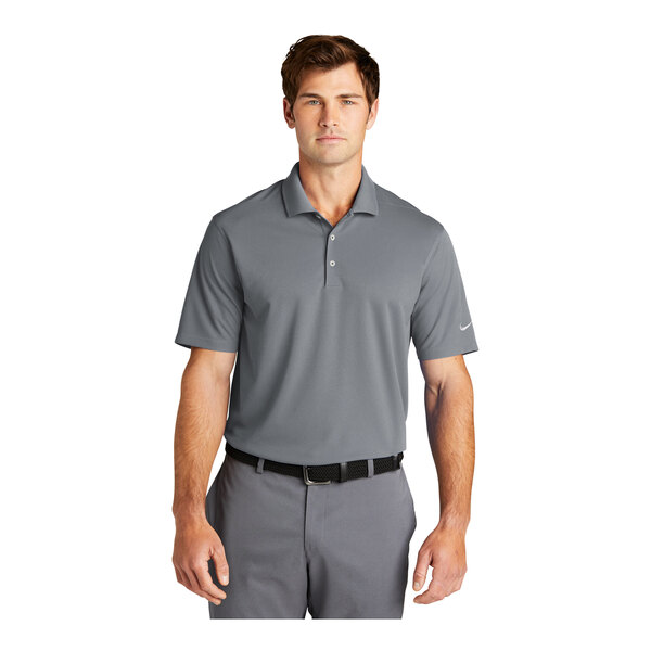 A man wearing a grey Nike Dri-Fit polo shirt with a collar.