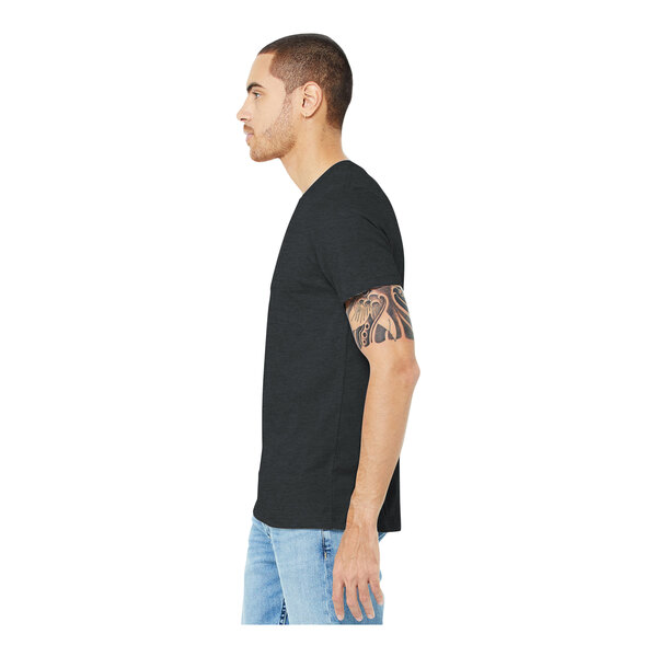 A man in a dark gray Bella + Canvas customizable t-shirt and jeans.