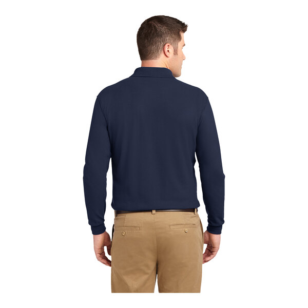 A man wearing a Port Authority navy long sleeve polo shirt.