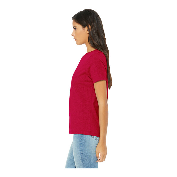 A woman wearing a heather red Bella + Canvas customizable t-shirt.