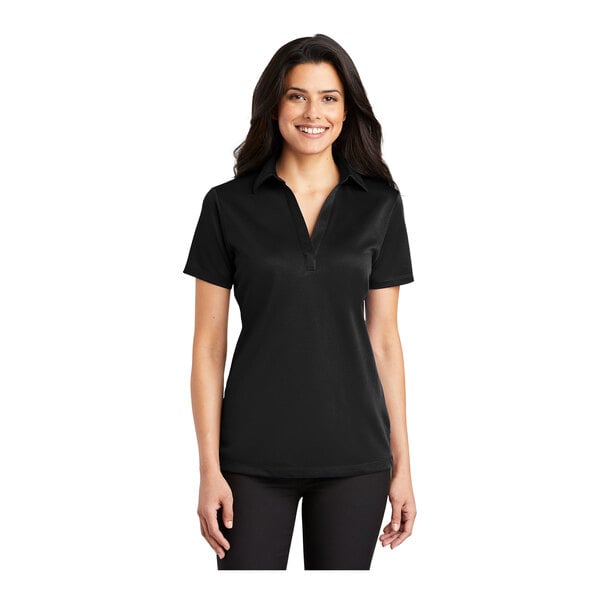 A woman wearing a black Port Authority silk touch polo shirt.
