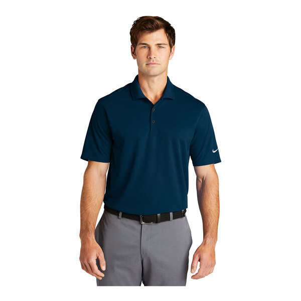 A man wearing a navy Nike Dri-Fit polo shirt.