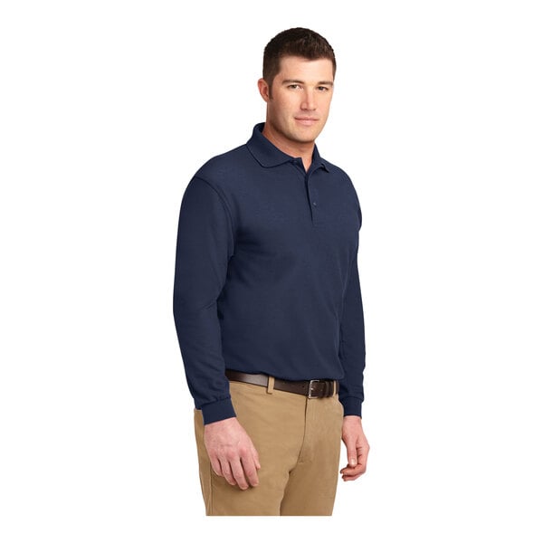 A man wearing a navy Port Authority® long sleeve polo shirt.