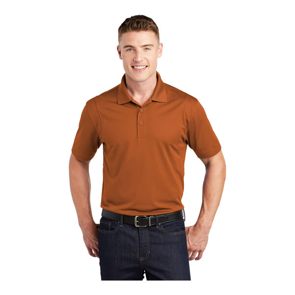 A man wearing a Texas orange Sport-Tek short sleeve polo shirt.