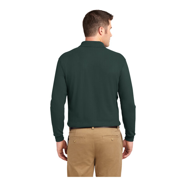 A man wearing a dark green Port Authority® long sleeve polo shirt.