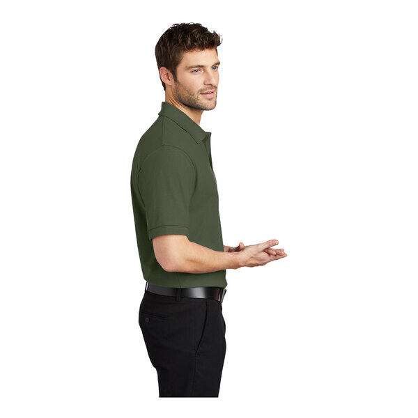 A man wearing a Port Authority clover green polo shirt.