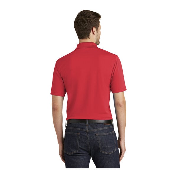 A man wearing a red Port Authority polo shirt.