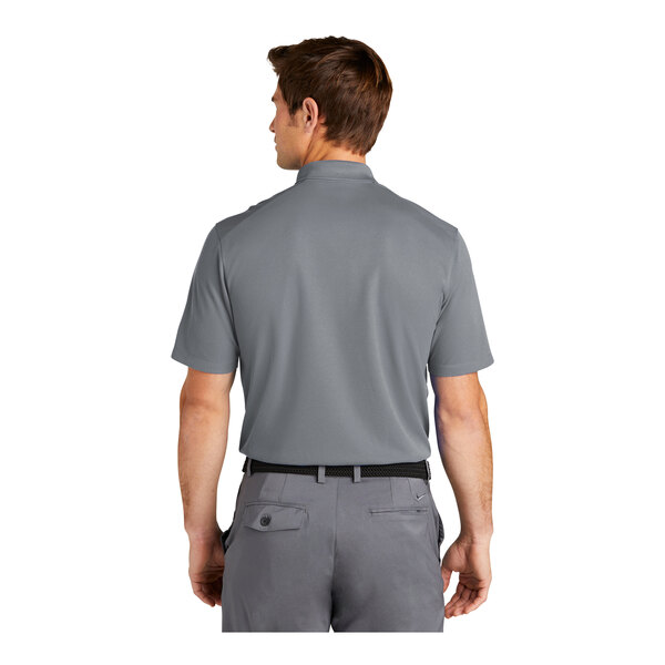 A man wearing a cool grey Nike Dri-Fit polo shirt.