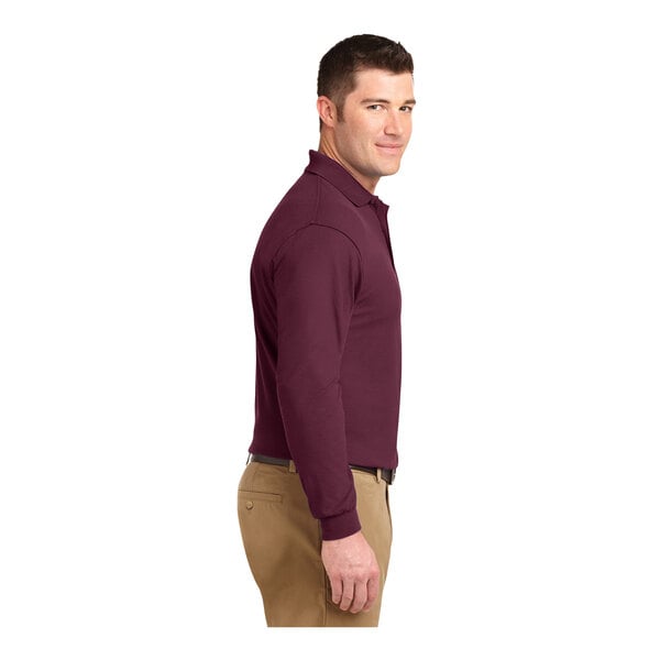 A man wearing a Port Authority® burgundy long sleeve polo shirt.
