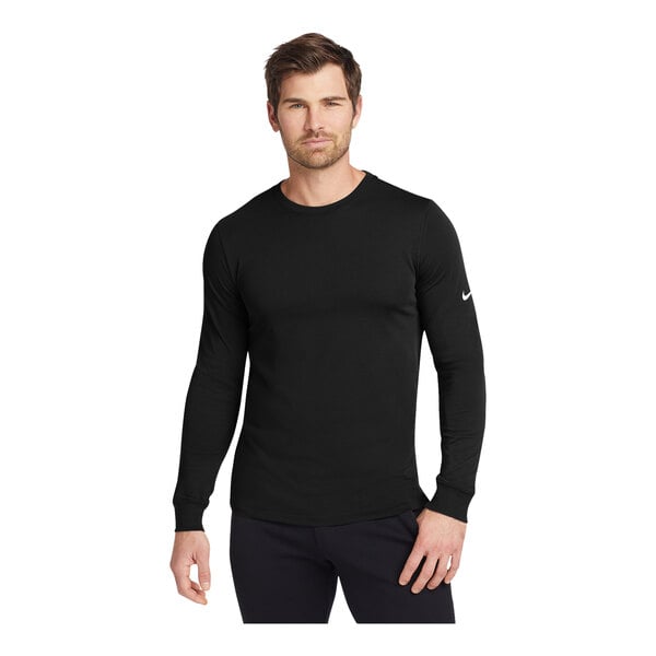 A man wearing a black Nike Dri-FIT long sleeve T-shirt.