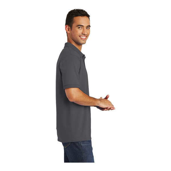 A man wearing a charcoal Port & Company polo shirt.