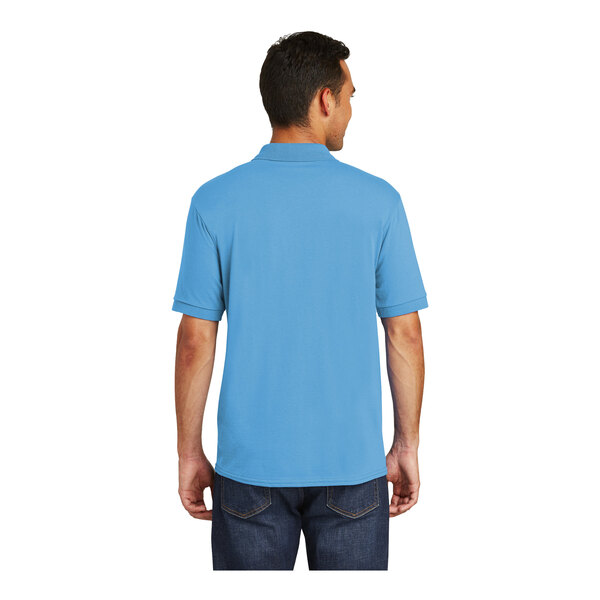 A man wearing a blue Port & Company polo shirt.