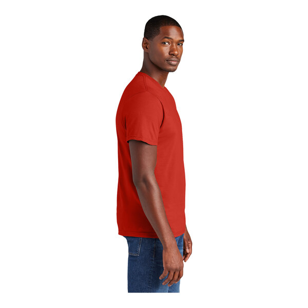 A man wearing a District Fiery Red short sleeve t-shirt.