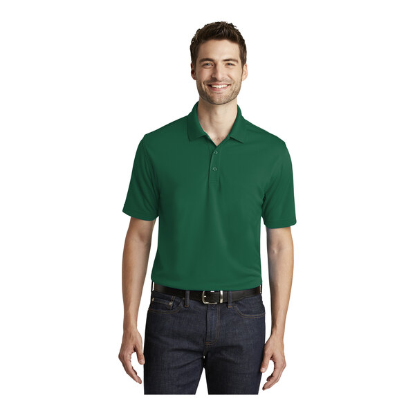 A man wearing a Port Authority Dry Zone deep forest green polo shirt.