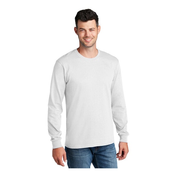 A man wearing a white Port & Company long sleeve T-shirt.