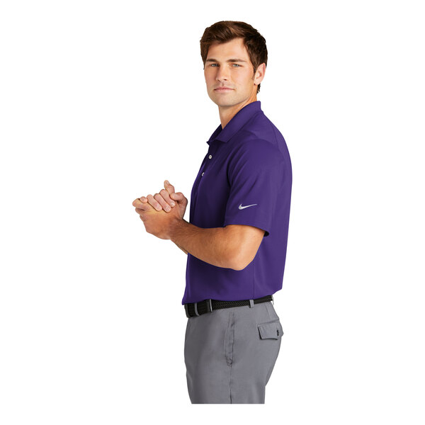 A man wearing a purple Nike Dri-Fit polo.
